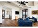 Spacious living room with hardwood floors, a fireplace, and access to a balcony at 24546 N 91St St, Scottsdale, AZ 85255