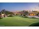 Landscaped backyard with a putting green, pool, and firepit at 24546 N 91St St, Scottsdale, AZ 85255