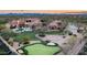 Sunset aerial view showing home, pool, putting green, and tennis court at 24546 N 91St St, Scottsdale, AZ 85255
