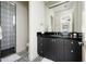 Stylish bathroom with black vanity, patterned tile floor and shower at 24546 N 91St St, Scottsdale, AZ 85255