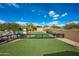 Artificial turf backyard with a fence and built in fire pit at 24546 N 91St St, Scottsdale, AZ 85255