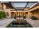 Stunning courtyard entry with water feature, pergola, and elegant landscaping at 24546 N 91St St, Scottsdale, AZ 85255
