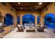 Evening view of covered patio with outdoor kitchen and seating area at 24546 N 91St St, Scottsdale, AZ 85255