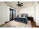 Large bedroom with hardwood floors, a plush bed, and access to a balcony at 24546 N 91St St, Scottsdale, AZ 85255