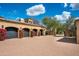 Motor court with three garages and flowering bushes at 24546 N 91St St, Scottsdale, AZ 85255