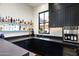Custom wet bar with extensive wine storage and sink at 24546 N 91St St, Scottsdale, AZ 85255