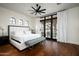 Bright bedroom with a comfortable bed, hardwood floors and access to a private balcony at 24546 N 91St St, Scottsdale, AZ 85255