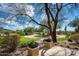 Landscaped backyard with a curved walkway and outdoor seating area at 24546 N 91St St, Scottsdale, AZ 85255