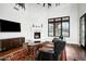 Spacious living room featuring a fireplace, hardwood floors, and large windows at 24546 N 91St St, Scottsdale, AZ 85255