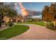 Landscaped front yard with a curved brick driveway leading to a stunning home at 24546 N 91St St, Scottsdale, AZ 85255