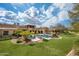Landscaped backyard with a pool and large grassy area at 24546 N 91St St, Scottsdale, AZ 85255