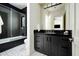 Modern bathroom with dark-colored cabinetry and geometric patterned tile at 24546 N 91St St, Scottsdale, AZ 85255