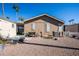 Tan colored house exterior with a well manicured lawn at 9302 E Broadway Rd # 1, Mesa, AZ 85208