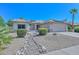 Single story home with a landscaped front yard and solar panels at 15574 W Vista Grande Ln, Surprise, AZ 85374