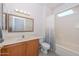 Bathroom with tub, single vanity, and wood cabinet at 15574 W Vista Grande Ln, Surprise, AZ 85374