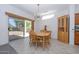 Bright dining room with wooden table and chairs, near sliding glass door at 15574 W Vista Grande Ln, Surprise, AZ 85374
