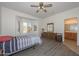 Bedroom with bay window, ceiling fan, and ensuite bathroom access at 15574 W Vista Grande Ln, Surprise, AZ 85374
