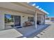 Relaxing covered patio with wicker furniture and built-in grill at 15574 W Vista Grande Ln, Surprise, AZ 85374