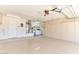 Attached garage with laundry area and storage cabinets at 15574 W Vista Grande Ln, Surprise, AZ 85374