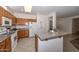 Well-equipped kitchen featuring wood cabinets and a breakfast bar at 15574 W Vista Grande Ln, Surprise, AZ 85374