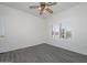 Simple bedroom with ceiling fan and window with shutters at 15574 W Vista Grande Ln, Surprise, AZ 85374