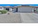 Front view of house showcasing landscaping and garage at 15574 W Vista Grande Ln, Surprise, AZ 85374