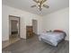 Bedroom with gray flooring, ceiling fan, and access to other rooms at 15574 W Vista Grande Ln, Surprise, AZ 85374