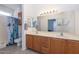 Double vanity bathroom with light wood cabinets and tiled floor at 15574 W Vista Grande Ln, Surprise, AZ 85374