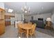 Charming dining area with a wooden table and chandelier, adjacent to kitchen at 15574 W Vista Grande Ln, Surprise, AZ 85374