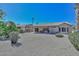 Large backyard with gravel, desert plants, and covered patio at 15574 W Vista Grande Ln, Surprise, AZ 85374
