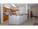 Kitchen with wood cabinets, an island, and modern appliances at 15574 W Vista Grande Ln, Surprise, AZ 85374