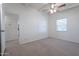 Bright bedroom with neutral carpet, ceiling fan, and access to another room at 1331 E Pierson St, Phoenix, AZ 85014