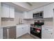 Modern kitchen with white shaker cabinets and stainless steel appliances at 1331 E Pierson St, Phoenix, AZ 85014