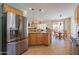 Kitchen features an island, stainless steel appliances, and light wood cabinets at 7527 E Elderberry Way, Gold Canyon, AZ 85118