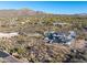 Aerial view of a large, modern home under construction on a hillside at 40575 N 109Th Pl, Scottsdale, AZ 85262