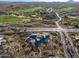 Aerial view of a modern home under construction near a golf course at 40575 N 109Th Pl, Scottsdale, AZ 85262