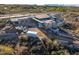 Aerial view of a modern house under construction on a hillside lot, materials on site at 40575 N 109Th Pl, Scottsdale, AZ 85262