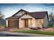 Charming house exterior with stone and tile accents, plus landscaping at 21354 E Sparrow Dr, Queen Creek, AZ 85142