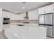 Modern kitchen with white cabinets, quartz countertops, and stainless steel appliances at 21354 E Sparrow Dr, Queen Creek, AZ 85142