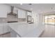 Modern kitchen with island, stainless steel appliances, and white cabinetry at 21354 E Sparrow Dr, Queen Creek, AZ 85142