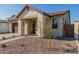 Modern home exterior with light-colored stone and landscaping at 21354 E Sparrow Dr, Queen Creek, AZ 85142
