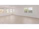Spacious living area with neutral tile floors and abundant natural light at 21354 E Sparrow Dr, Queen Creek, AZ 85142