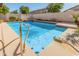 Inviting rectangular pool with a shallow entry and a waterfall feature at 10413 W Ashbrook Pl, Avondale, AZ 85392