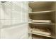 Well-organized pantry with wire shelving and wooden drawers at 10413 W Ashbrook Pl, Avondale, AZ 85392