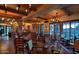 Rustic-chic dining room with multiple tables and large windows at 40575 N 109Th Pl, Scottsdale, AZ 85262