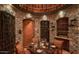 Impressive wine cellar with stone walls and a tasting area at 40575 N 109Th Pl, Scottsdale, AZ 85262