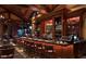 Long bar with wood finishes and a wide selection of spirits at 40575 N 109Th Pl, Scottsdale, AZ 85262
