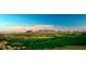 Aerial view of a luxury community with a golf course and mountain backdrop at 40575 N 109Th Pl, Scottsdale, AZ 85262