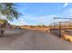 Open landscape with dirt road leading to horse facilities at 13330 E Jomax Rd, Scottsdale, AZ 85262