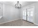 Dining room with French doors and modern light fixture at 10220 N 109Th Ave, Sun City, AZ 85351